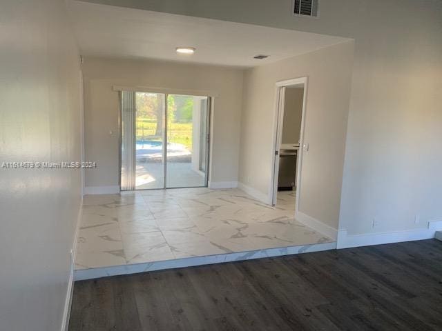 spare room with light hardwood / wood-style flooring