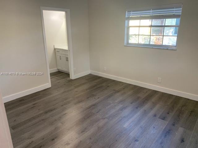 unfurnished room featuring dark hardwood / wood-style flooring