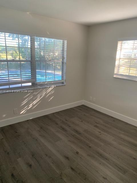 unfurnished room featuring dark hardwood / wood-style floors