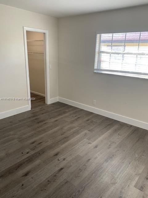 unfurnished room featuring dark hardwood / wood-style floors