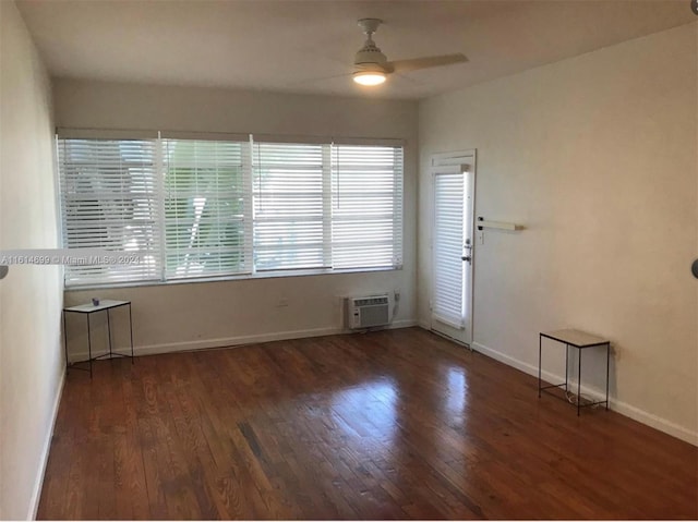 entryway featuring a wealth of natural light, a wall mounted air conditioner, ceiling fan, and dark hardwood / wood-style flooring