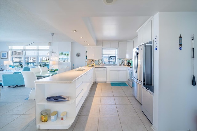 kitchen featuring kitchen peninsula, dishwasher, white cabinetry, stainless steel refrigerator, and light tile patterned flooring