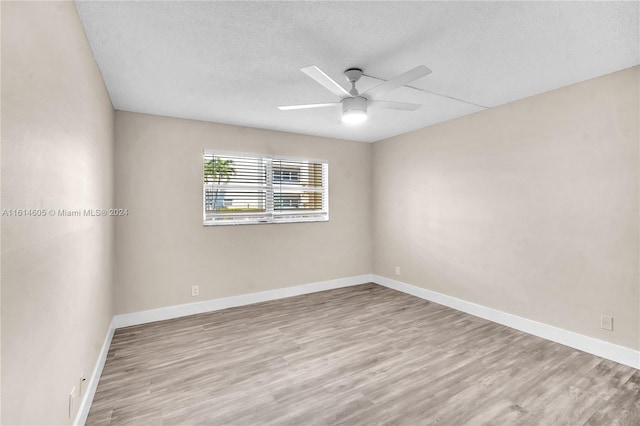 unfurnished room featuring ceiling fan, a textured ceiling, and light hardwood / wood-style flooring