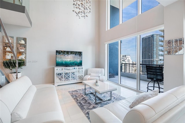 tiled living room featuring a high ceiling