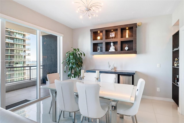 dining area featuring light tile patterned floors and a notable chandelier