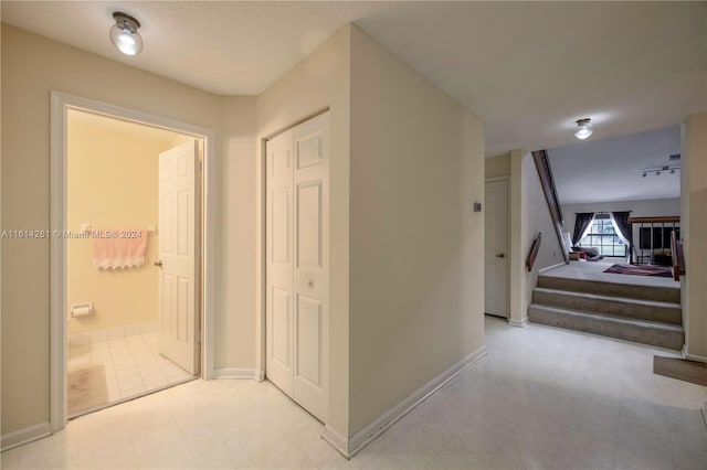 hallway with a textured ceiling