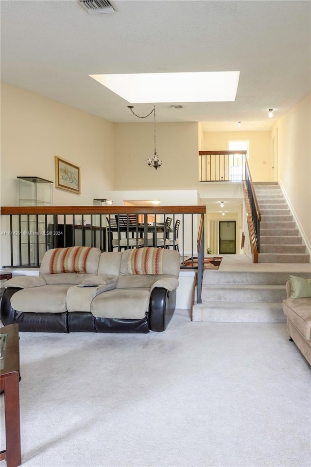 living room with a skylight and carpet