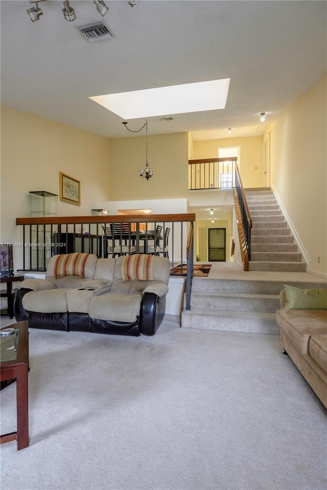 living room featuring carpet and a skylight