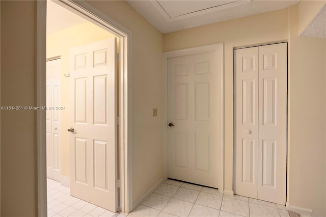 corridor with light tile patterned floors