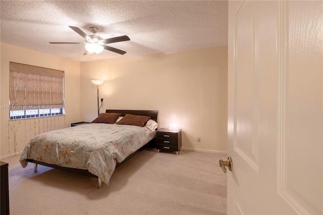 carpeted bedroom featuring a textured ceiling and ceiling fan