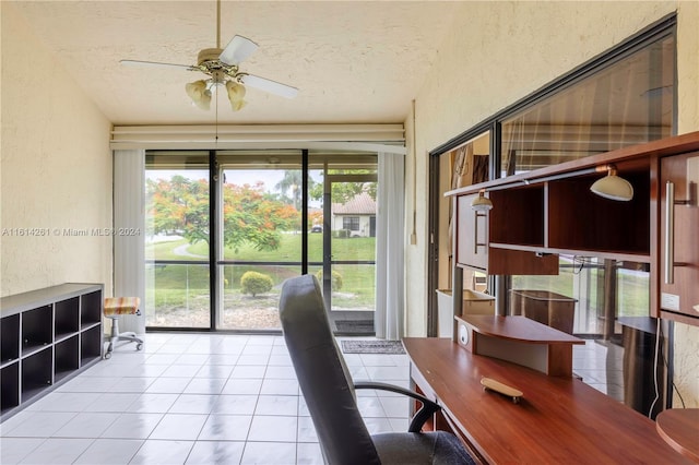 office space featuring a textured ceiling, ceiling fan, and light tile patterned flooring