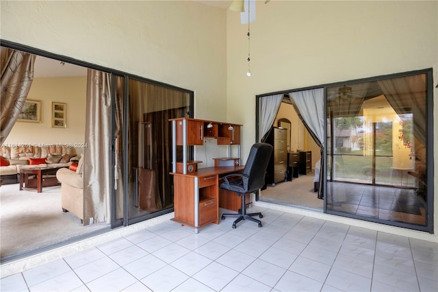 office with light colored carpet and high vaulted ceiling