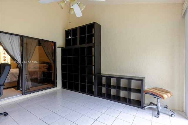 interior space with ceiling fan and light tile patterned floors