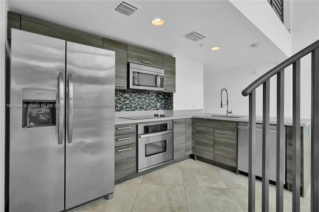 421 Meridian Ave Unit 16, Miami Beach, FL 33139 - kitchen featuring stainless steel appliances, a sink, light countertops, backsplash, and recessed lighting