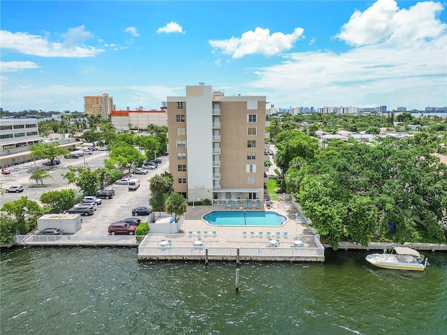 exterior space featuring a water view and a community pool