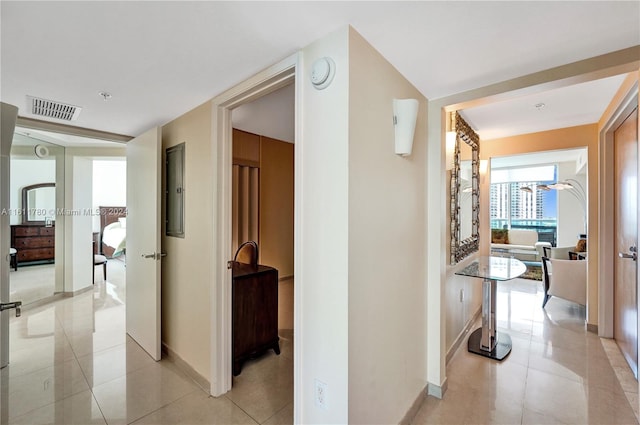 hall featuring light tile patterned floors