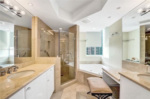 bathroom featuring plus walk in shower, vanity, and tile patterned floors