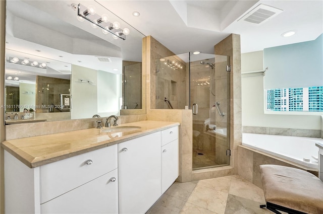 bathroom featuring vanity and separate shower and tub