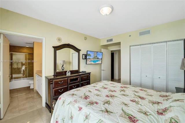 bedroom with ensuite bathroom and a closet