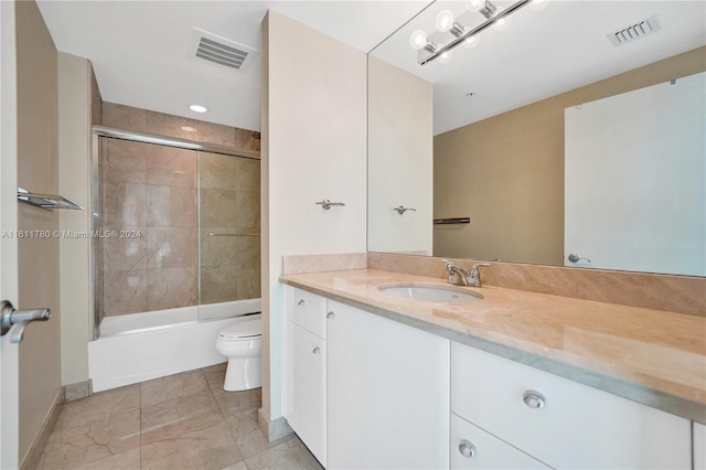 full bathroom with vanity, toilet, and shower / bath combination with glass door