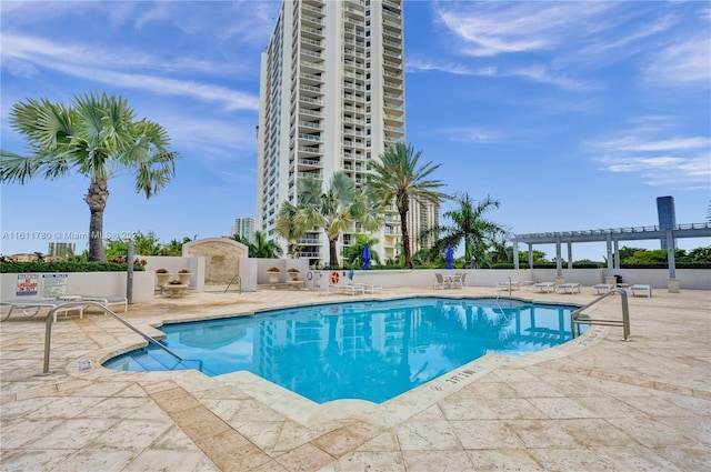 view of swimming pool with a pergola and a patio