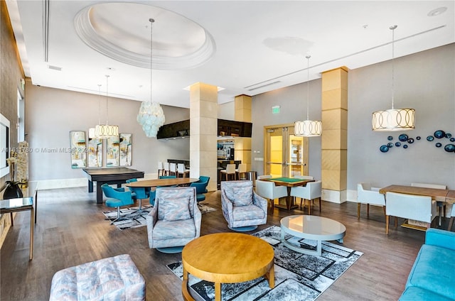 living room featuring a tray ceiling, dark hardwood / wood-style floors, a high ceiling, and pool table