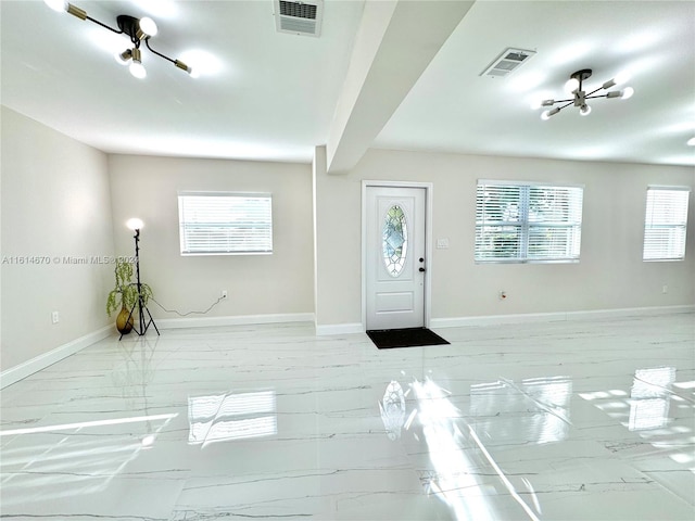 entrance foyer with a healthy amount of sunlight and beamed ceiling