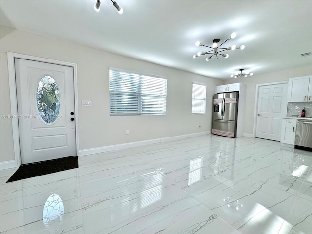 entrance foyer with a notable chandelier and a healthy amount of sunlight