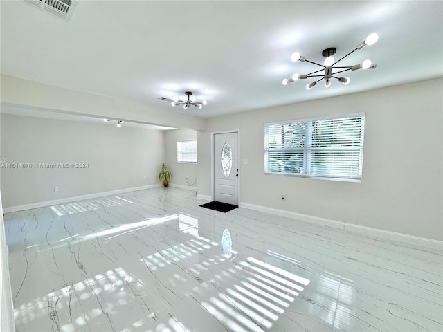 entryway with a healthy amount of sunlight and a chandelier