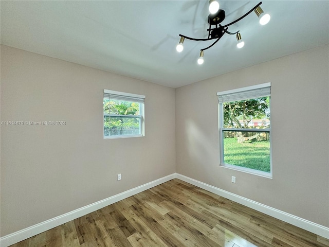 unfurnished room featuring light hardwood / wood-style flooring and plenty of natural light