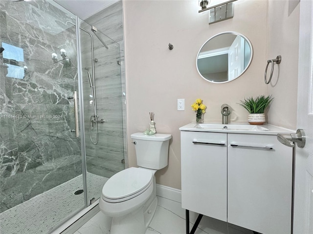 bathroom with a shower with shower door, vanity, and toilet