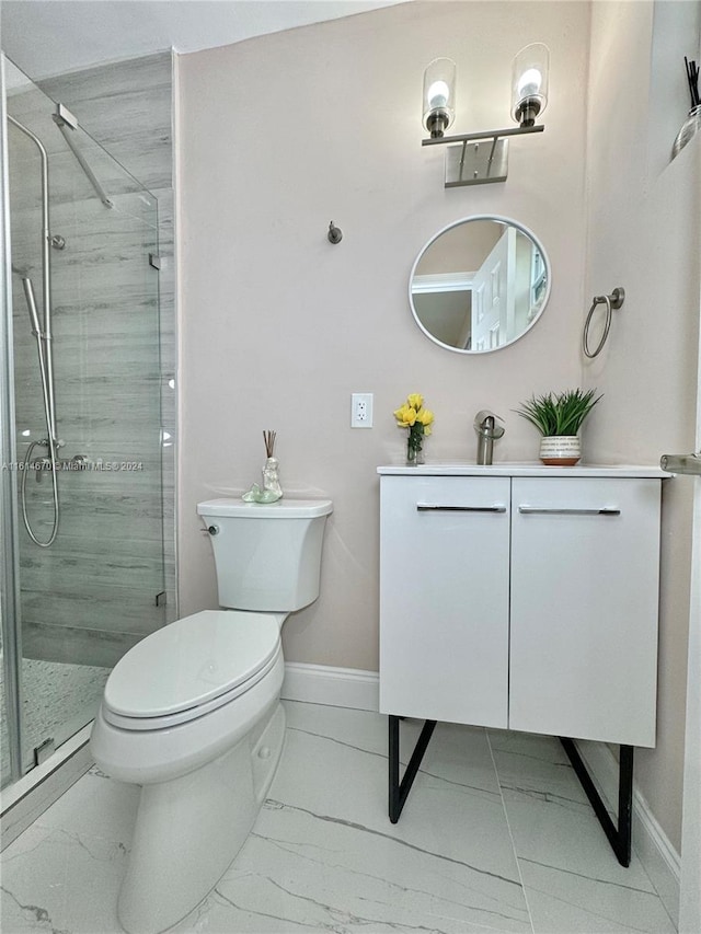 bathroom with vanity, a shower with shower door, and toilet