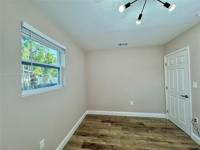 unfurnished room with hardwood / wood-style flooring