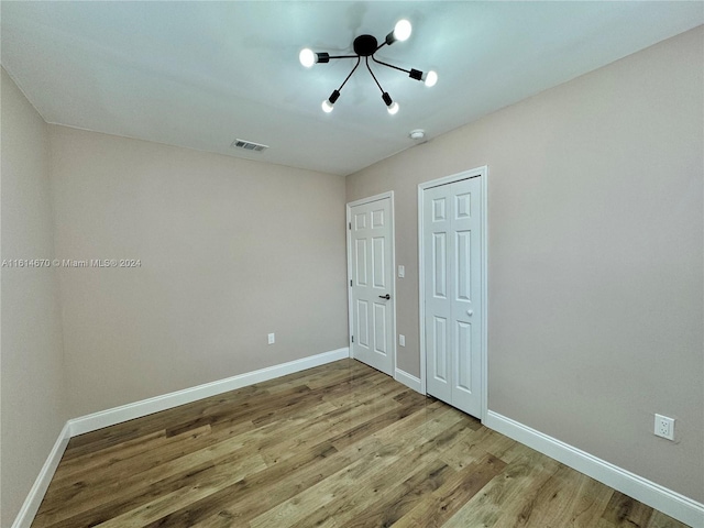 unfurnished bedroom featuring hardwood / wood-style floors