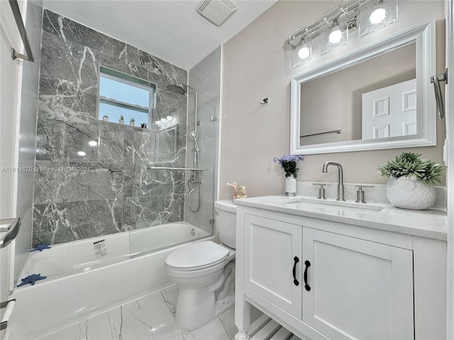 full bathroom featuring tiled shower / bath, vanity, and toilet