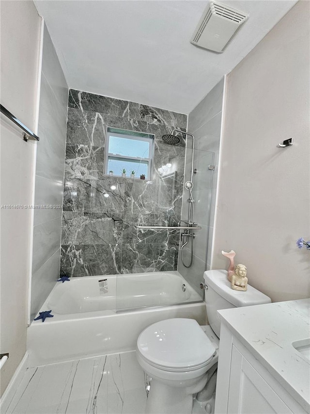 full bathroom featuring tiled shower / bath combo, vanity, and toilet