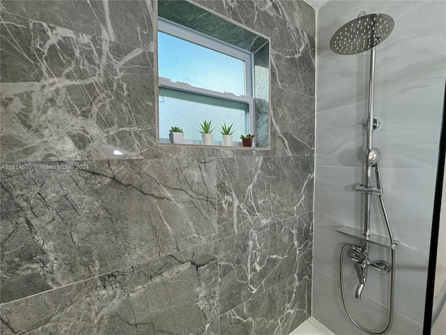 bathroom with tiled shower