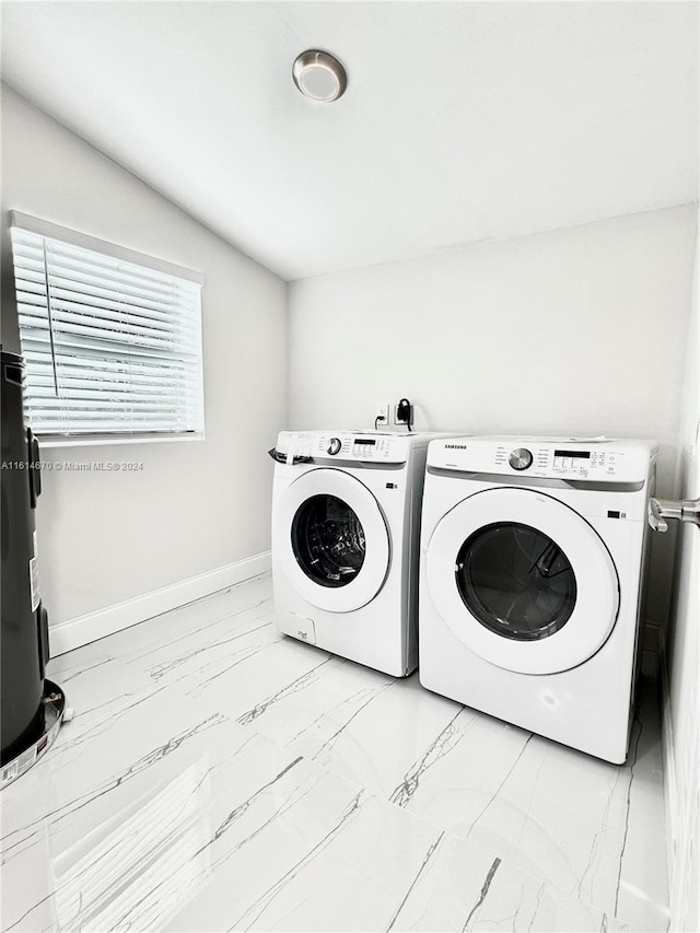 clothes washing area with washer and dryer