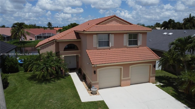 mediterranean / spanish home with a front lawn and a garage