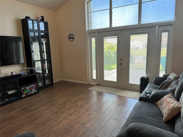 doorway to outside featuring a towering ceiling and french doors