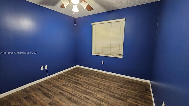 empty room with ceiling fan, hardwood / wood-style floors, and a textured ceiling