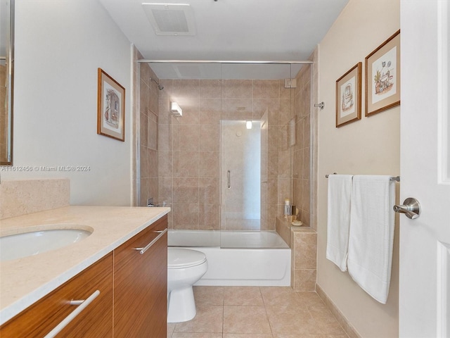 full bathroom with toilet, vanity, tile patterned flooring, and tiled shower / bath combo