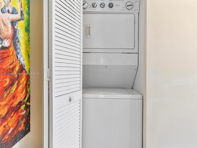 clothes washing area featuring stacked washer / dryer