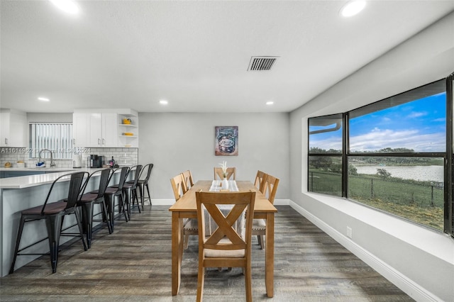 dining space with dark hardwood / wood-style flooring