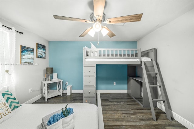 bedroom with dark hardwood / wood-style flooring and ceiling fan