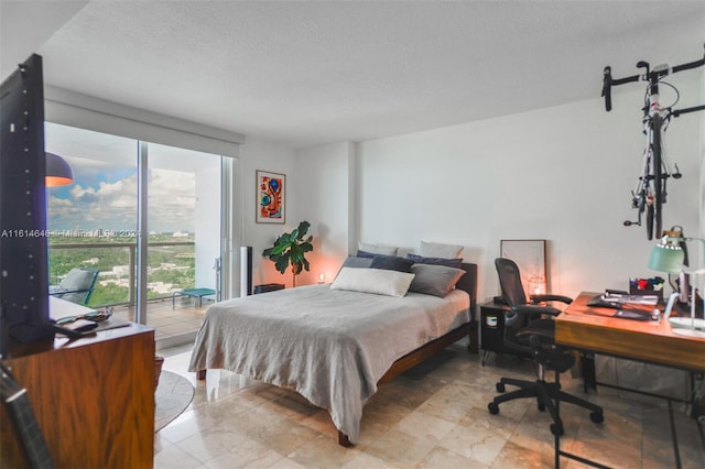2101 Brickell Ave Unit 2009, Miami, FL 33129 - bedroom featuring access to outside, a textured ceiling, and an office area