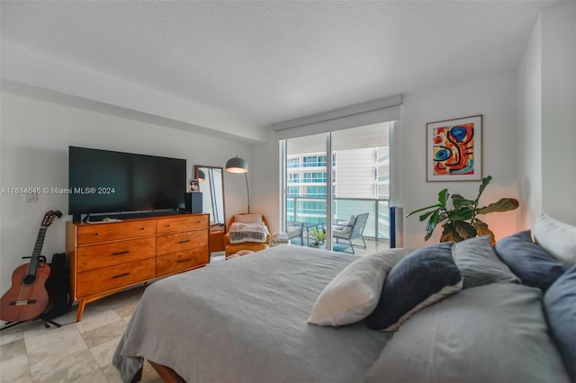 bedroom featuring a textured ceiling and access to exterior