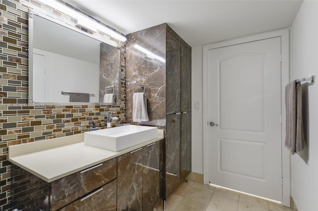 bathroom featuring decorative backsplash, tile patterned floors, and vanity