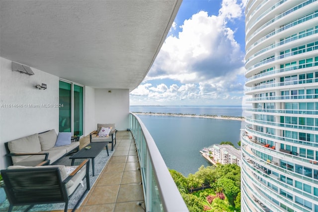 balcony with a water view and an outdoor hangout area