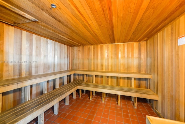 view of sauna / steam room featuring wooden walls, wood ceiling, and tile patterned flooring